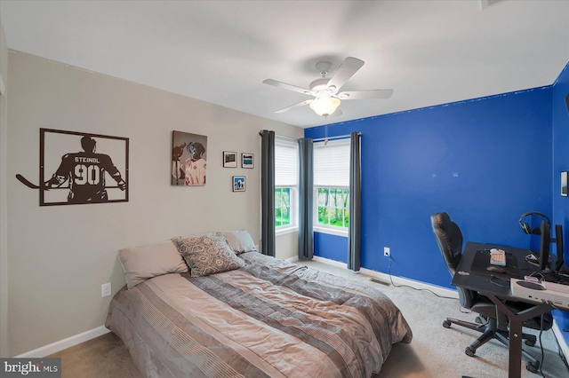 carpeted bedroom featuring baseboards and ceiling fan
