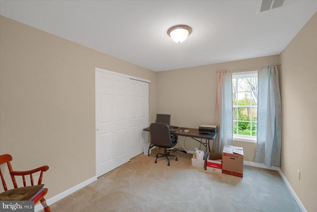 carpeted home office with visible vents and baseboards