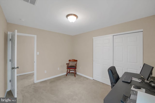 office space featuring light colored carpet, baseboards, and visible vents