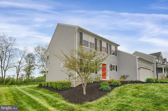 view of front of house featuring an attached garage and a front yard