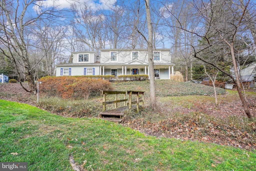 view of front of property with a porch and a front yard