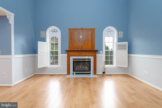 729 Rosecroft Ct, Forest Hill, MD 21050 - unfurnished living room with a towering ceiling, a high end fireplace, plenty of natural light, light wood finished floors, and baseboards