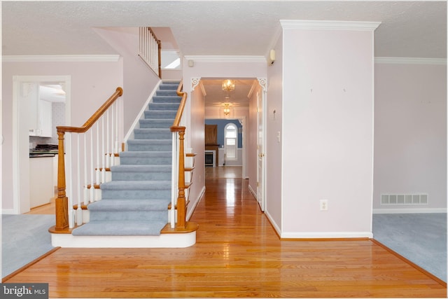 729 Rosecroft Ct, Forest Hill, MD 21050 - foyer featuring light wood finished floors, stairway, crown molding, baseboards, and a textured ceiling