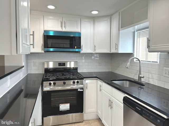 371 Chaplin St SE, Washington, DC 20019 - kitchen with appliances with stainless steel finishes, a sink, white cabinets, and recessed lighting
