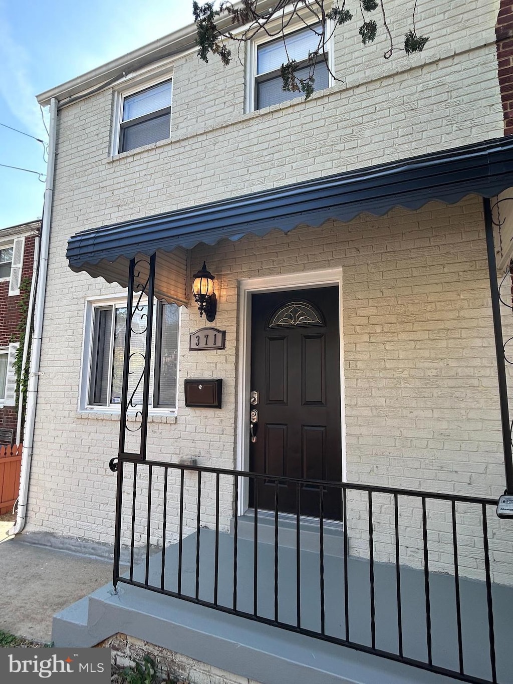 property entrance with brick siding
