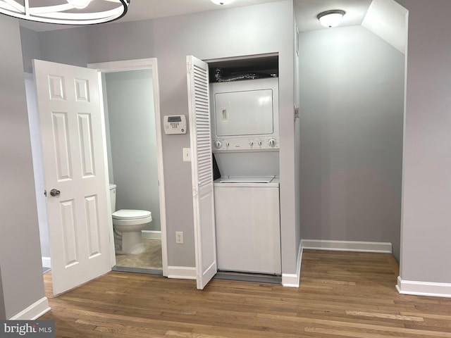 371 Chaplin St SE, Washington, DC 20019 - laundry room with stacked washer / dryer, wood finished floors, and baseboards