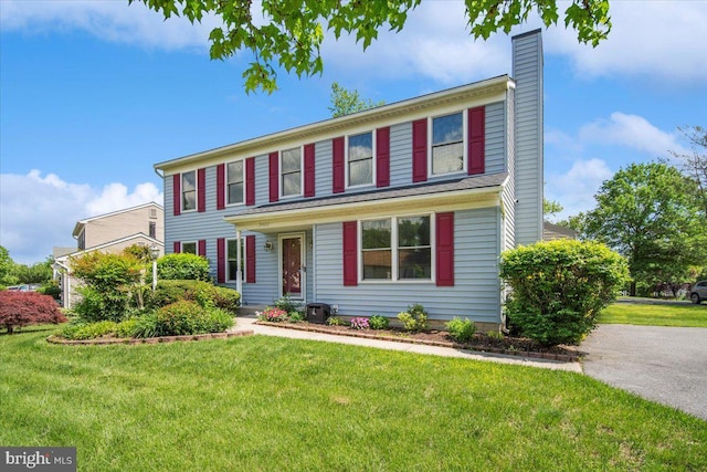 9402 Glen Ridge Dr, Laurel, MD 20723 - colonial inspired home with a chimney and a front lawn