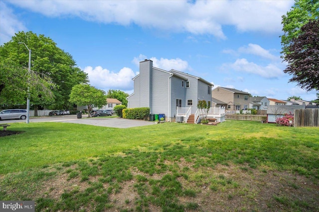 9402 Glen Ridge Dr, Laurel, MD 20723 - view of property exterior featuring a chimney, central AC, and a residential view