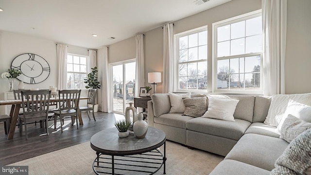 living area with recessed lighting and wood finished floors