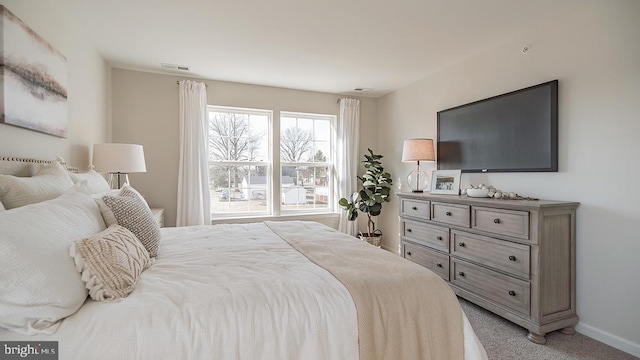 bedroom with baseboards, carpet, and visible vents