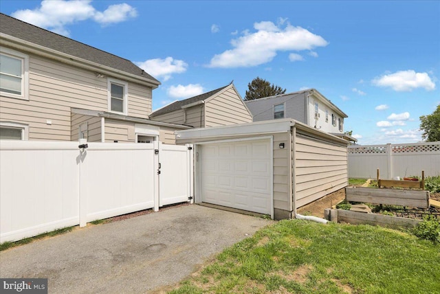 304 Charles Rd, Lancaster, PA 17603 - garage featuring fence, driveway, a garden, and a gate