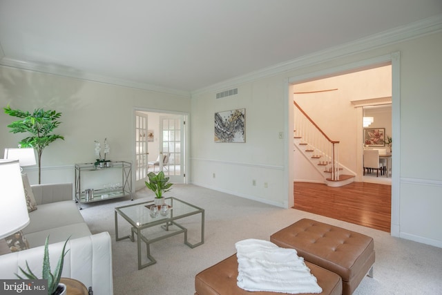 living room featuring stairway, crown molding, carpet floors, and baseboards