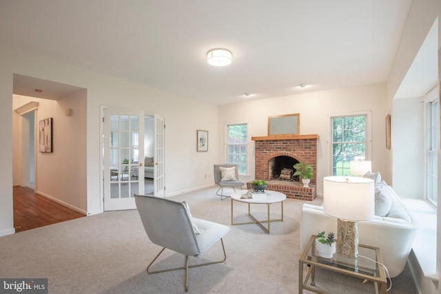 living area with carpet floors, healthy amount of natural light, baseboards, and a fireplace