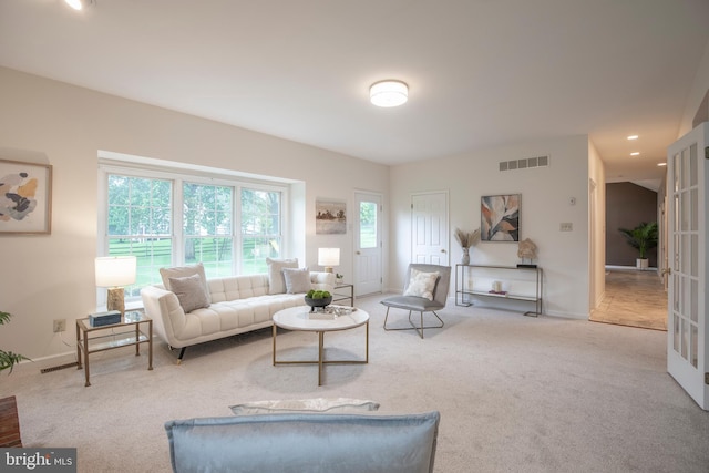 living area featuring carpet floors, baseboards, and recessed lighting