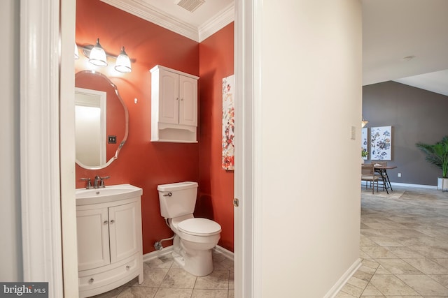half bathroom with baseboards, crown molding, toilet, and vanity