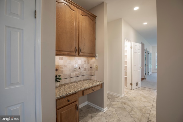 corridor featuring baseboards and recessed lighting