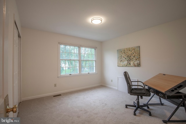 carpeted office space with baseboards