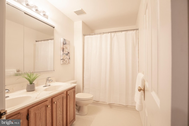 full bath with toilet and double vanity