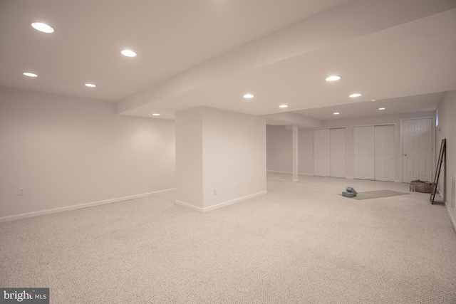 finished basement with recessed lighting, light carpet, and baseboards