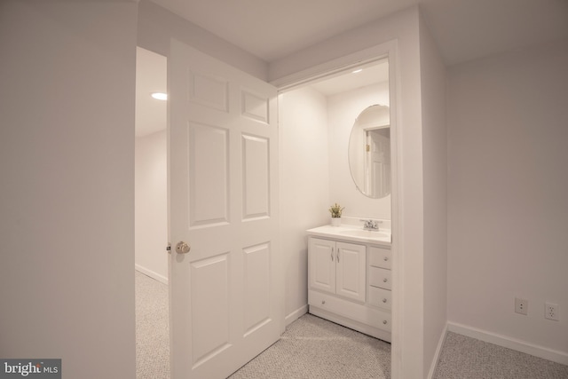 bathroom with baseboards and vanity