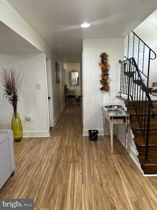 1305 Wendover Ct, District Heights, MD 20747 - corridor featuring wood finished floors, stairs, baseboards, and arched walkways