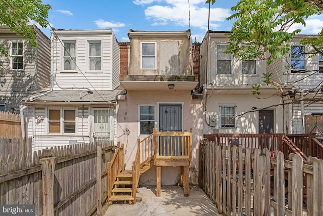 1213 Washington Blvd, Baltimore, MD 21230 - view of front of property with stucco siding and a fenced backyard