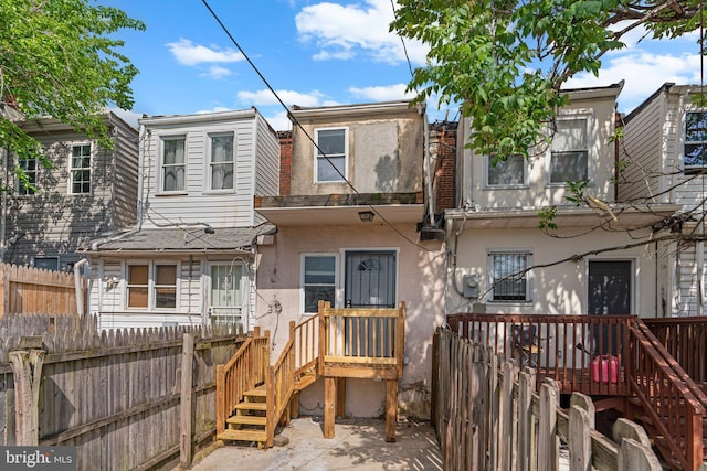 1213 Washington Blvd, Baltimore, MD 21230 - view of front of home with stucco siding and fence
