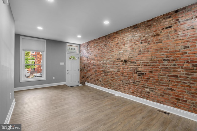 1213 Washington Blvd, Baltimore, MD 21230 - spare room with baseboards, wood finished floors, brick wall, and recessed lighting