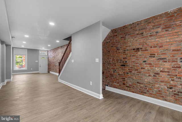 1213 Washington Blvd, Baltimore, MD 21230 - unfurnished living room with brick wall, baseboards, stairs, wood finished floors, and recessed lighting
