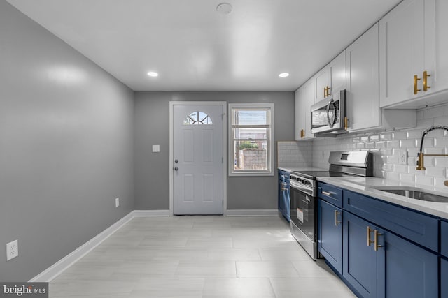 1213 Washington Blvd, Baltimore, MD 21230 - kitchen with appliances with stainless steel finishes, a sink, blue cabinets, white cabinetry, and baseboards