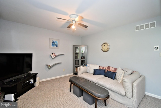 carpeted living room with visible vents, a ceiling fan, and baseboards