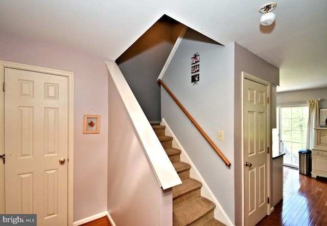 staircase with baseboards and hardwood / wood-style floors