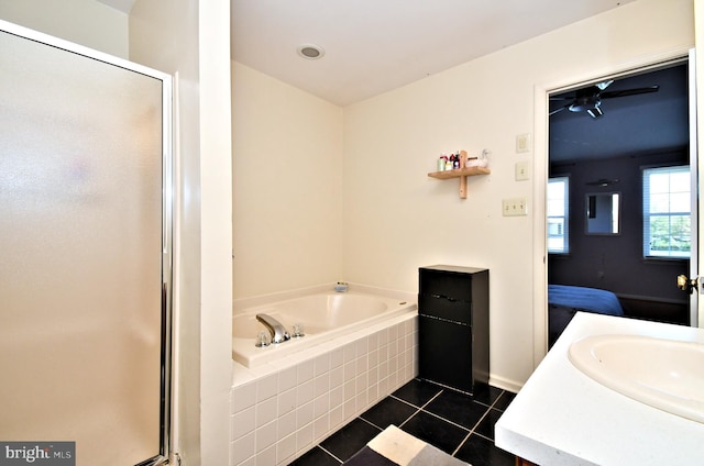 ensuite bathroom with tile patterned flooring, a ceiling fan, a shower stall, and a bath