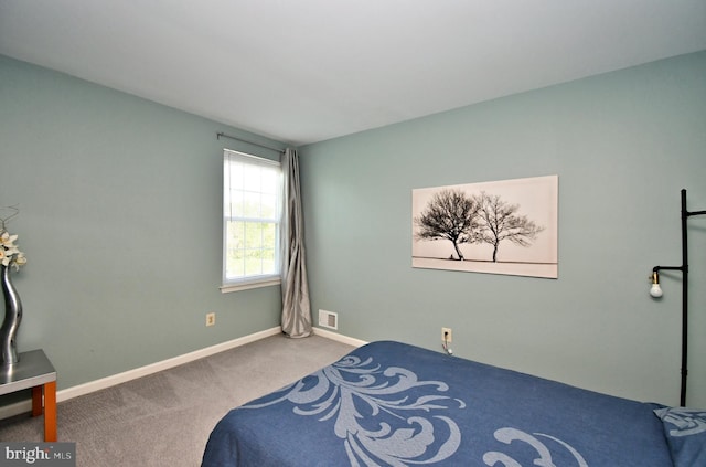 carpeted bedroom with baseboards and visible vents