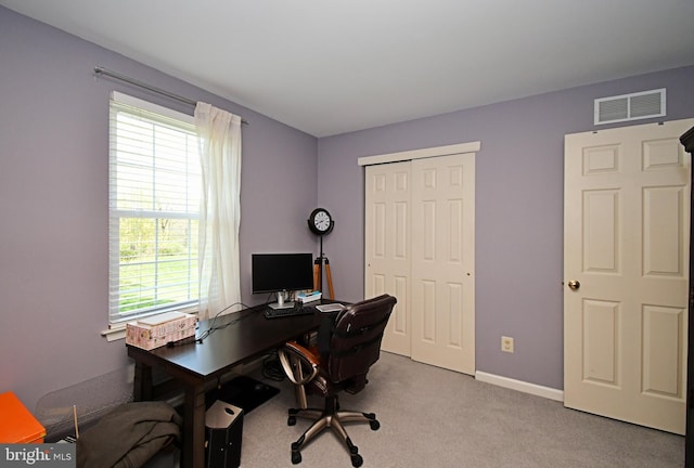 office featuring visible vents, baseboards, and light colored carpet