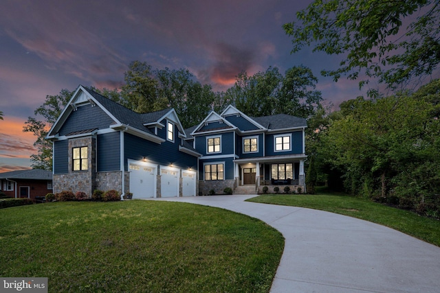 craftsman-style home with a garage, covered porch, a front yard, stone siding, and driveway