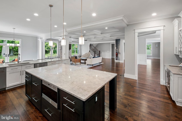 kitchen featuring a sink, stainless steel appliances, recessed lighting, white cabinetry, and a kitchen island