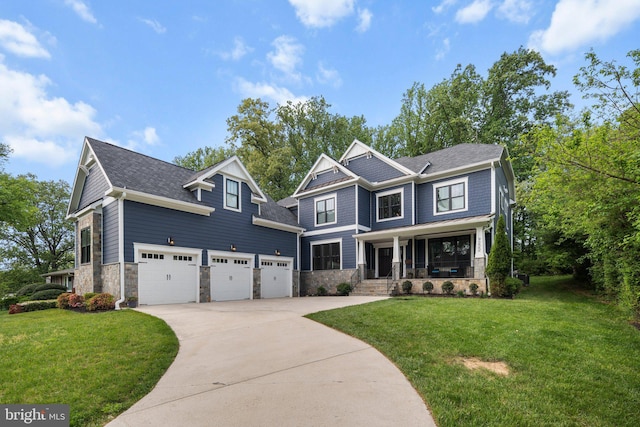 craftsman-style home featuring stone siding, a garage, concrete driveway, a front lawn, and a porch