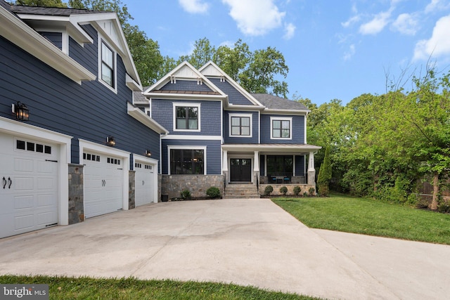 craftsman-style house featuring driveway, an attached garage, stone siding, a front yard, and a porch