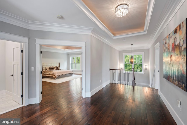 corridor with dark wood-style flooring, baseboards, an inviting chandelier, and a healthy amount of sunlight