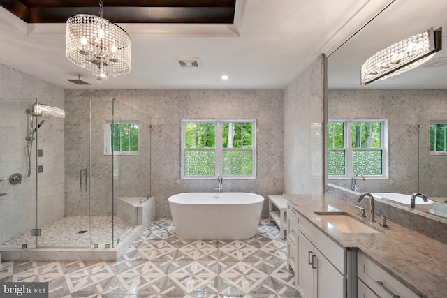 full bath with an inviting chandelier, vanity, a freestanding tub, recessed lighting, and a stall shower