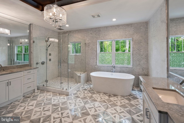 full bath with two vanities, plenty of natural light, a sink, and a stall shower