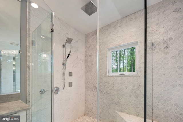 bathroom featuring a marble finish shower and vaulted ceiling