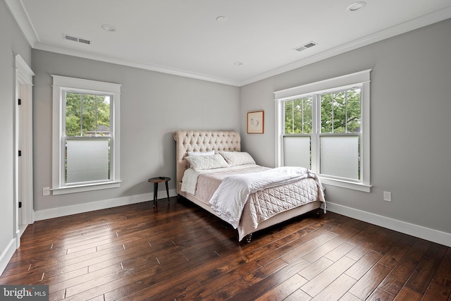 bedroom featuring multiple windows, crown molding, and visible vents