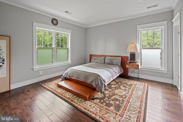 bedroom with multiple windows, visible vents, and crown molding