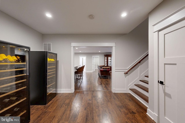 interior space featuring wine cooler, recessed lighting, visible vents, wood finished floors, and stairway