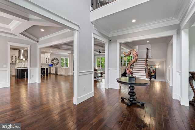 entryway featuring crown molding, stairs, a ceiling fan, decorative columns, and wood finished floors