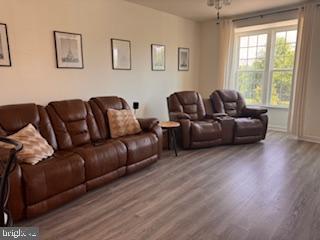 living area featuring baseboards and wood finished floors