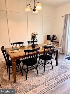 dining room featuring wood finished floors and a chandelier
