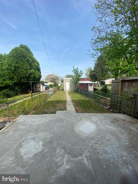 view of yard featuring fence and a patio